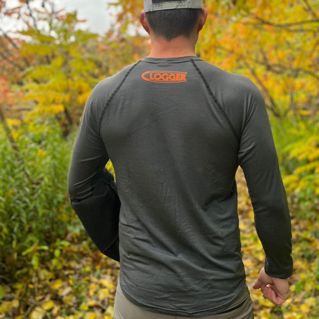 Photo of back view of Clogger 175 Merino Base Layer being worn by arborist Chris Sallows in the forest.